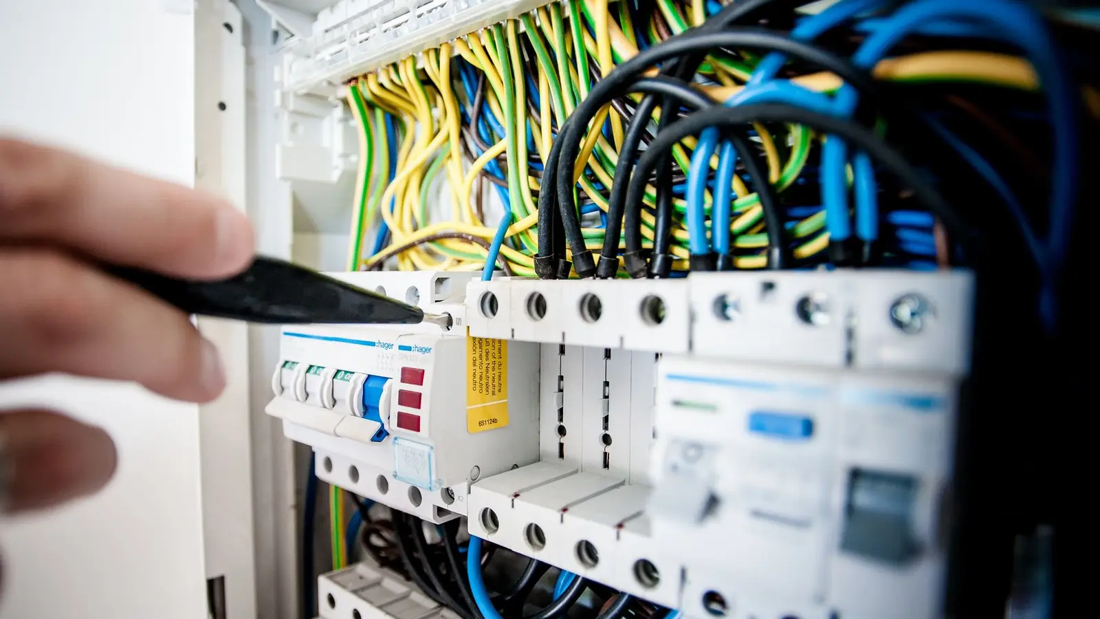 Electrician working on a residential breaker panel